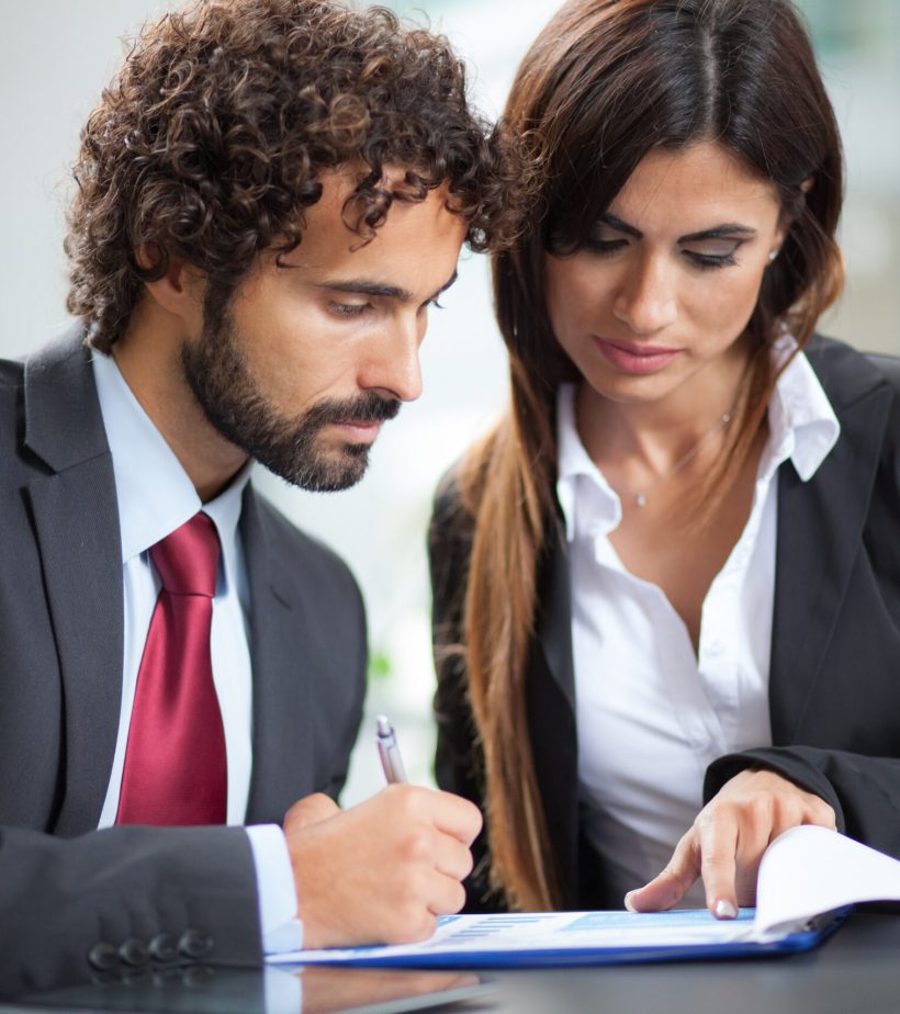 Business people working on a document while sitting in a coffee shop
